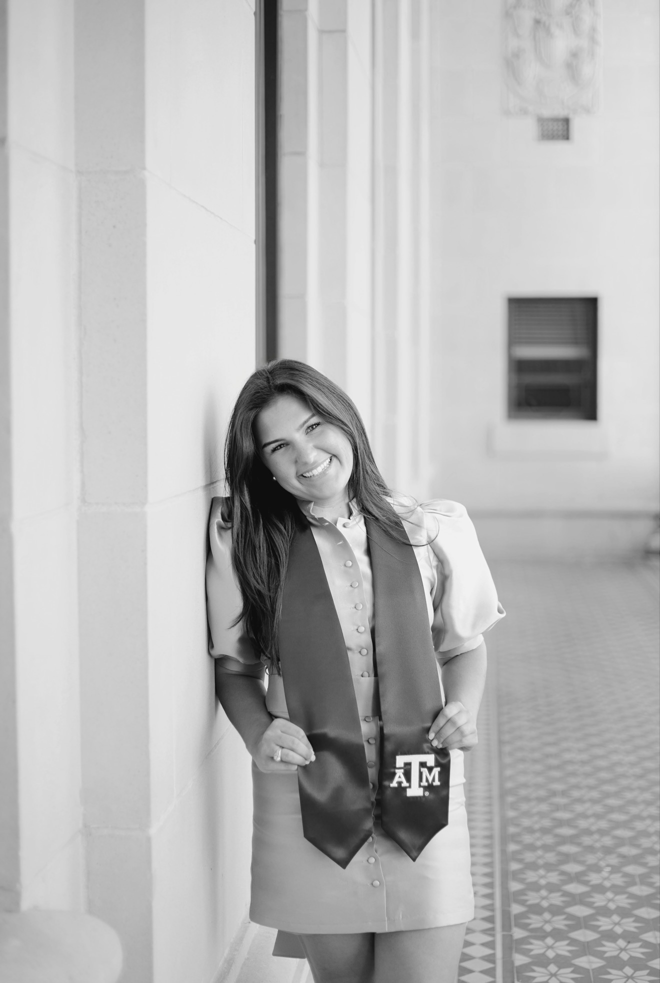 Dylan Wesselski smiling in a Texas A&M graduation stole